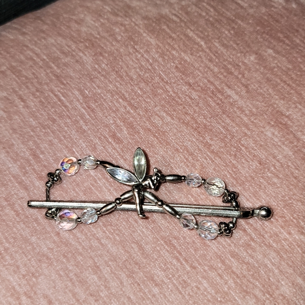 This is a silver-toned fairy hair clip with aurora borealis crystals.